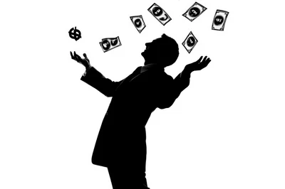 Silhouette Of A Businessman Juggling Money And Currency Symbols