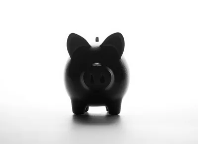 Black Piggy Bank Silhouette Against Bright White Background