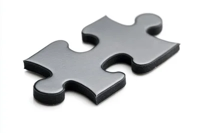 Single Black Jigsaw Puzzle Piece on White Background