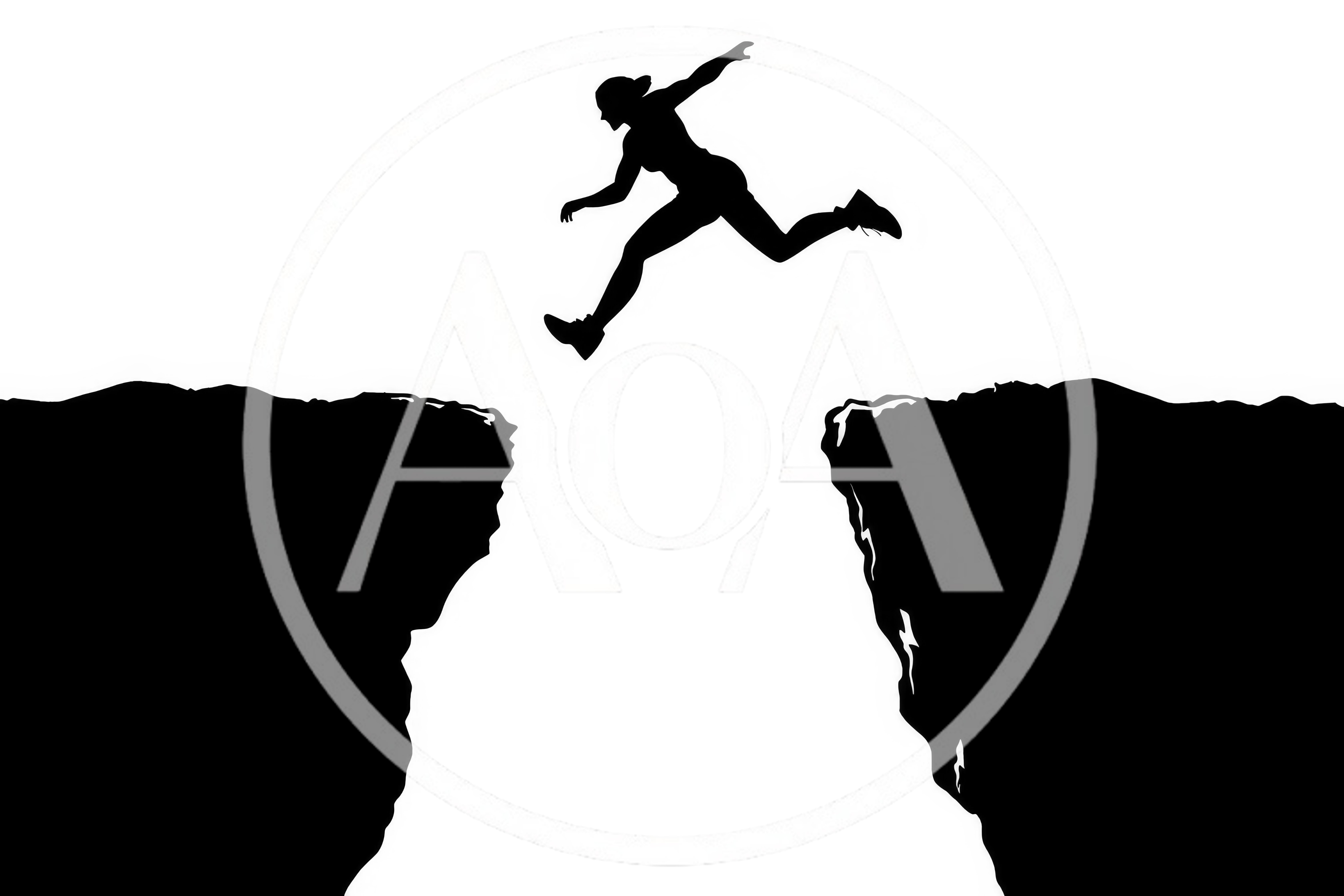 Silhouette Of A Person Jumping Across A Cliff Gap