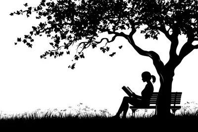 Silhouette Of A Woman Reading Under A Tree