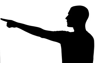 Silhouette Of A Man Pointing With His Finger