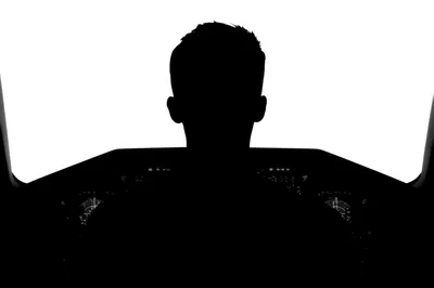 Silhouette Of A Pilot In An Airplane Cockpit