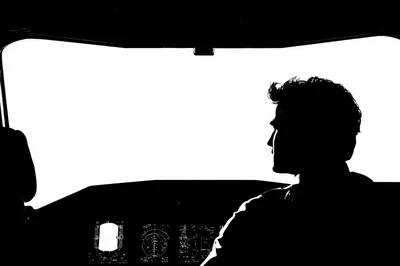 Silhouette Of A Pilot In An Airplane Cockpit
