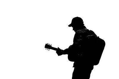 Silhouette Of A Musician Playing Acoustic Guitar