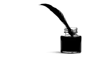 Quill Pen Resting In A Glass Inkwell