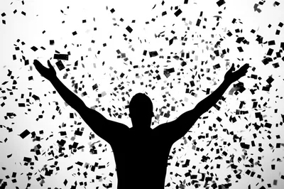 Silhouette Of A Man Celebrating With Falling Confetti