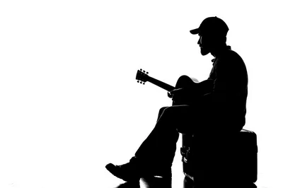 Silhouette Of A Man Playing Acoustic Guitar
