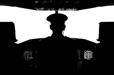 Silhouette Of A Pilot In An Airplane Cockpit
