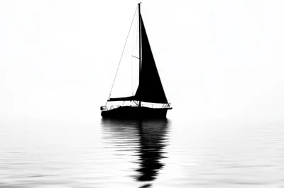 Silhouette Of A Sailboat On Calm Water