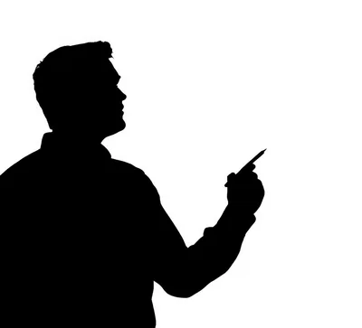 Silhouette Of A Man Pointing With A Pen