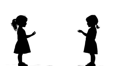 Silhouettes of Two Young Girls Facing Each Other