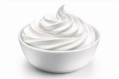 Swirled Whipped Cream In A White Ceramic Bowl
