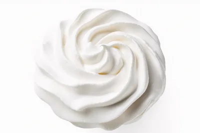 Swirled Whipped Cream Topping Isolated On White