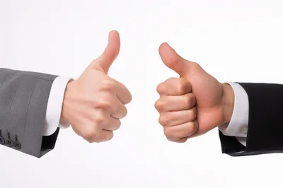 Two Businessmen Giving Thumbs Up Gestures