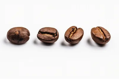 Four Roasted Coffee Beans Arranged In A Row