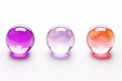 Three Colorful Glass Spheres On White Background