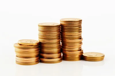 Stacks of Shiny Gold Coins on White Background