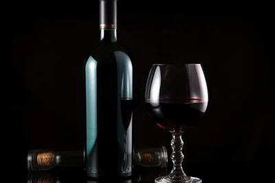 Wine Bottle And Glass On Black Background