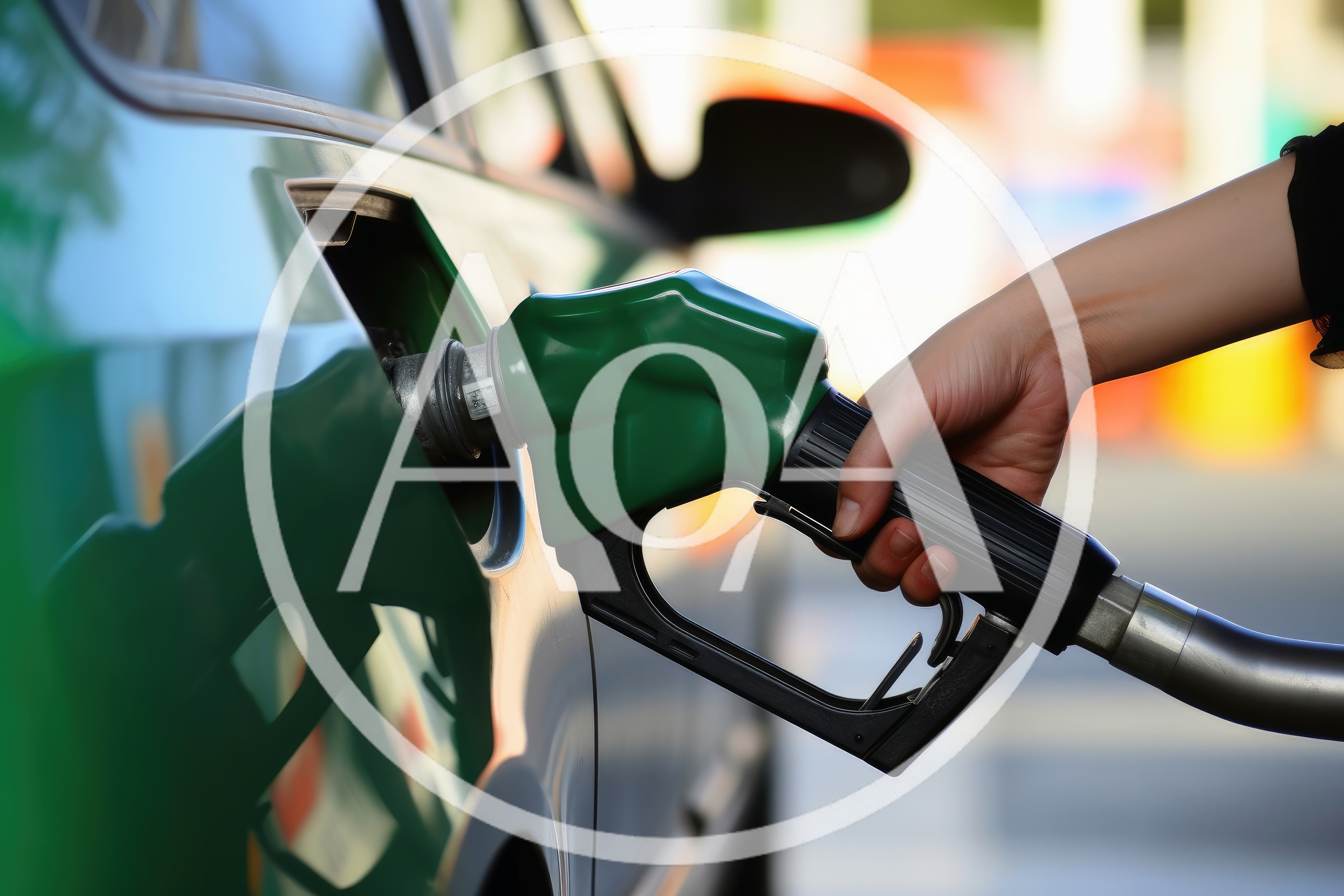 Person Refueling A Green Car At A Gas Station