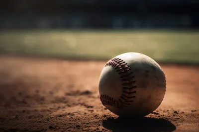 Baseball Resting On A Dirt Infield