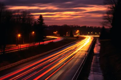 Long Exposure Traffic Light Trails On Highway At Sunset