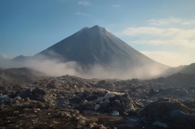 Massive Garbage Landfill Beneath A Smoking Volcanic Mountain