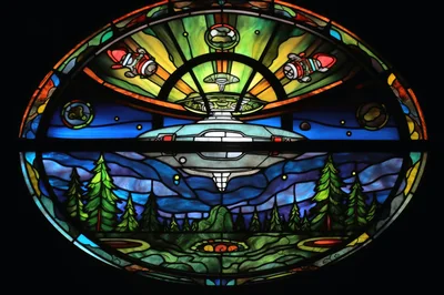 Stained Glass Window Featuring A Flying Saucer Over Forest