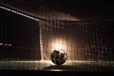 Soccer Ball Resting Inside A Stadium Goal Net