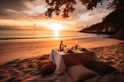 Romantic Beachside Dinner Setup At Sunset
