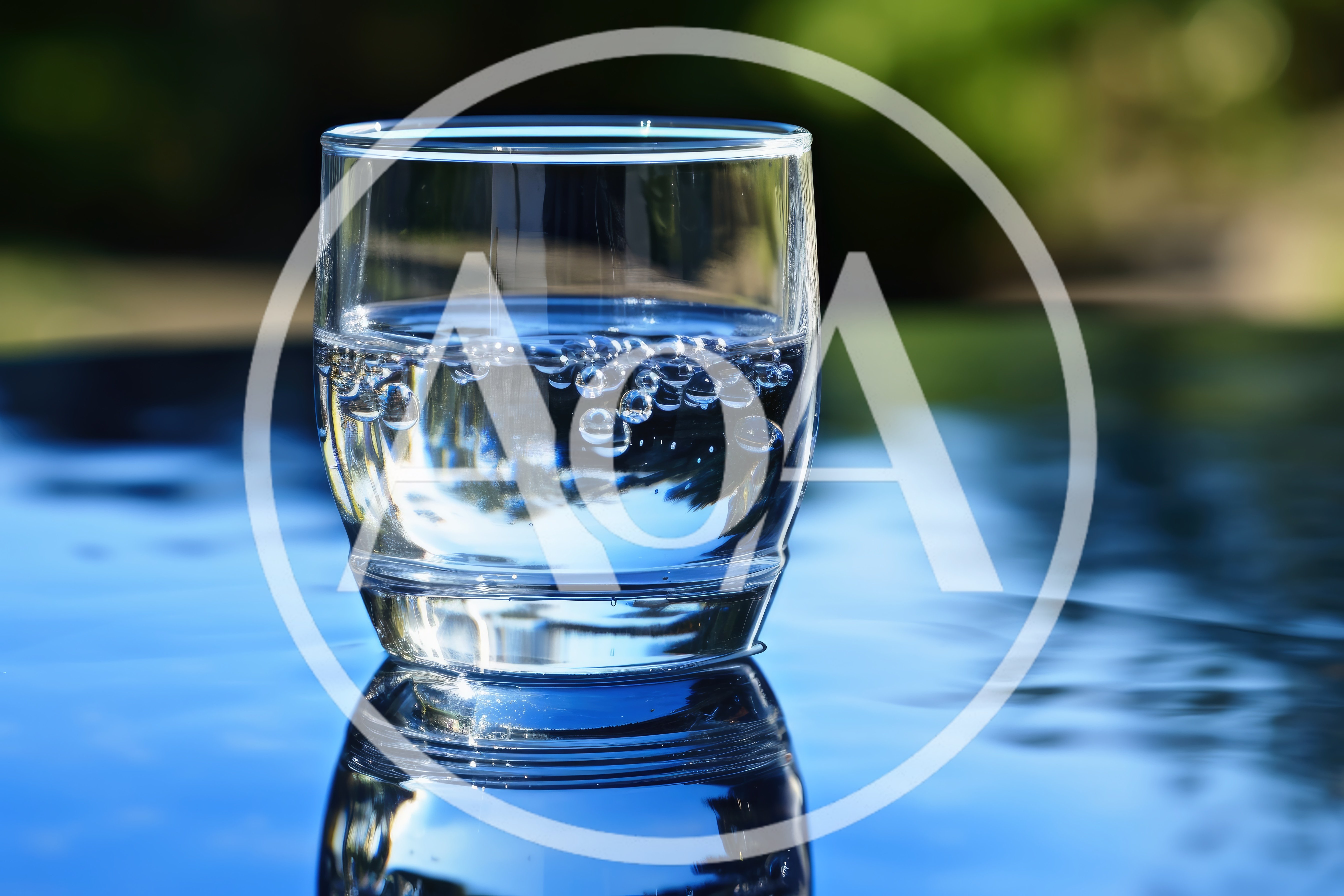 Glass Of Sparkling Water On A Reflective Surface