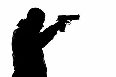 Silhouette Of A Man Holding A Handgun