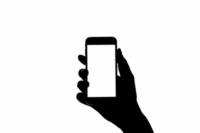 Silhouette Of A Hand Holding A Smartphone