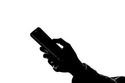 Silhouette Of A Hand Holding A Smartphone