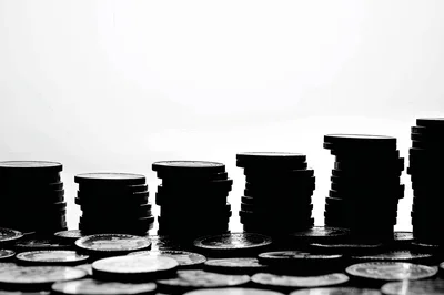 Silhouette Stacks Of Coins On A White Background