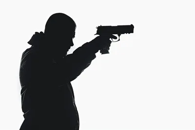 Silhouette Of A Man Holding A Handgun
