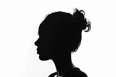 Silhouette Profile Of A Young Woman With Messy Bun