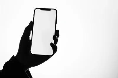 Silhouette Of A Hand Holding A Smartphone
