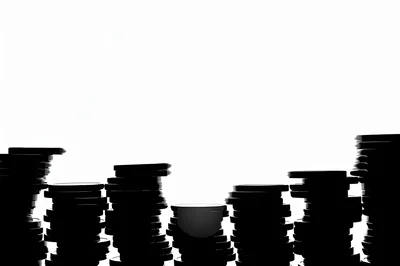 Silhouette Stacks Of Coins Against A White Background