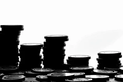 Silhouette Stacks of Coins on White Background
