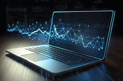 Laptop Displaying Glowing Financial Data Visualization