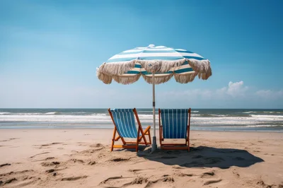 Two Striped Beach Chairs Under A Fringed Umbrella