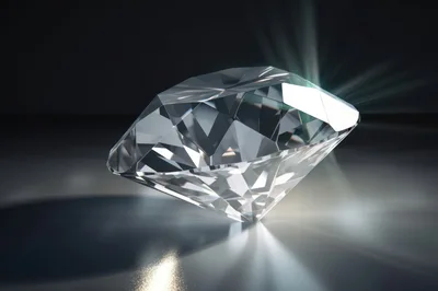 Brilliant Cut Diamond Resting On Reflective Surface