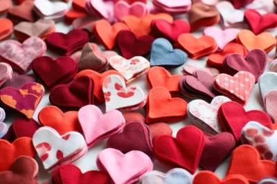 Assorted Fabric Hearts Scattered on White Surface