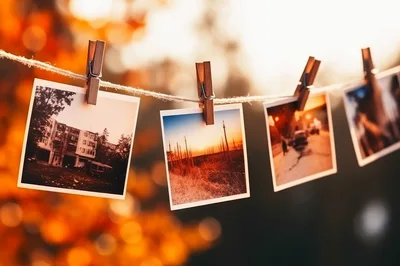 Polaroid Photos Hanging On A Clothesline Outdoors