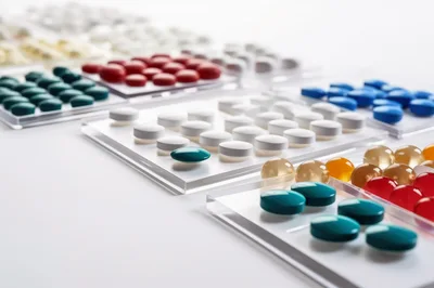 Assorted Pharmaceutical Pills Arranged on Transparent Trays