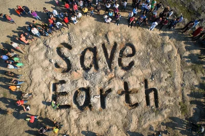 Aerial View Of People Gathering Around Save Earth Message