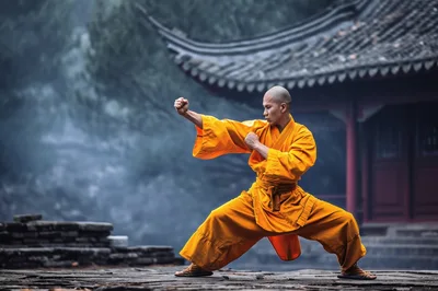 Shaolin Monk Performing Martial Arts In Traditional Temple Courtyard