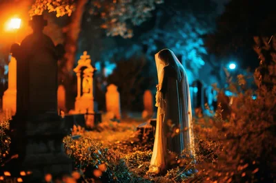 Ghostly Figure Standing In A Dark Cemetery At Night
