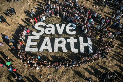 Aerial View Of People Gathering Around Save Earth Sign